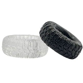 Black tyre resting on top of clear silicone tyre cock ring