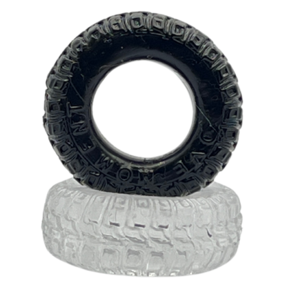 Black tyre resting on top of clear silicone tyre cock ring