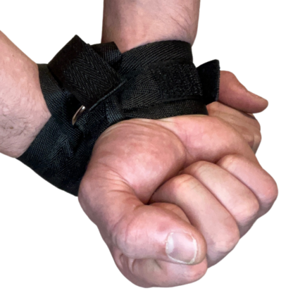 Black belt with metal ring, black velcrove wrist restraint on mans wrists behind back.